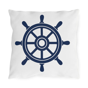 White pillow with a navy blue ship's wheel design on a white background